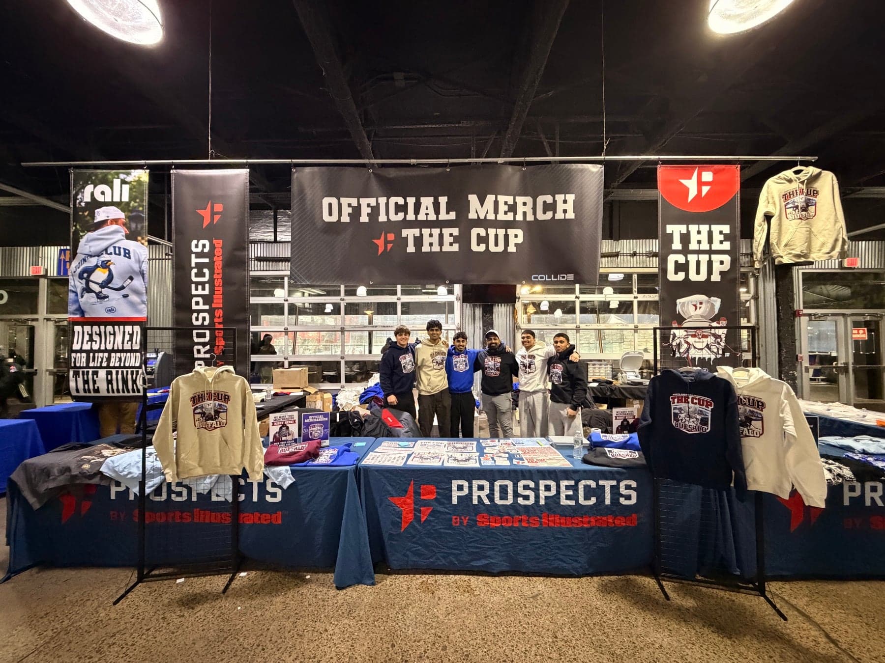The Collide booth at The Cup: Official Merch banner, Prospects by Sports Illustrated tables, the crew