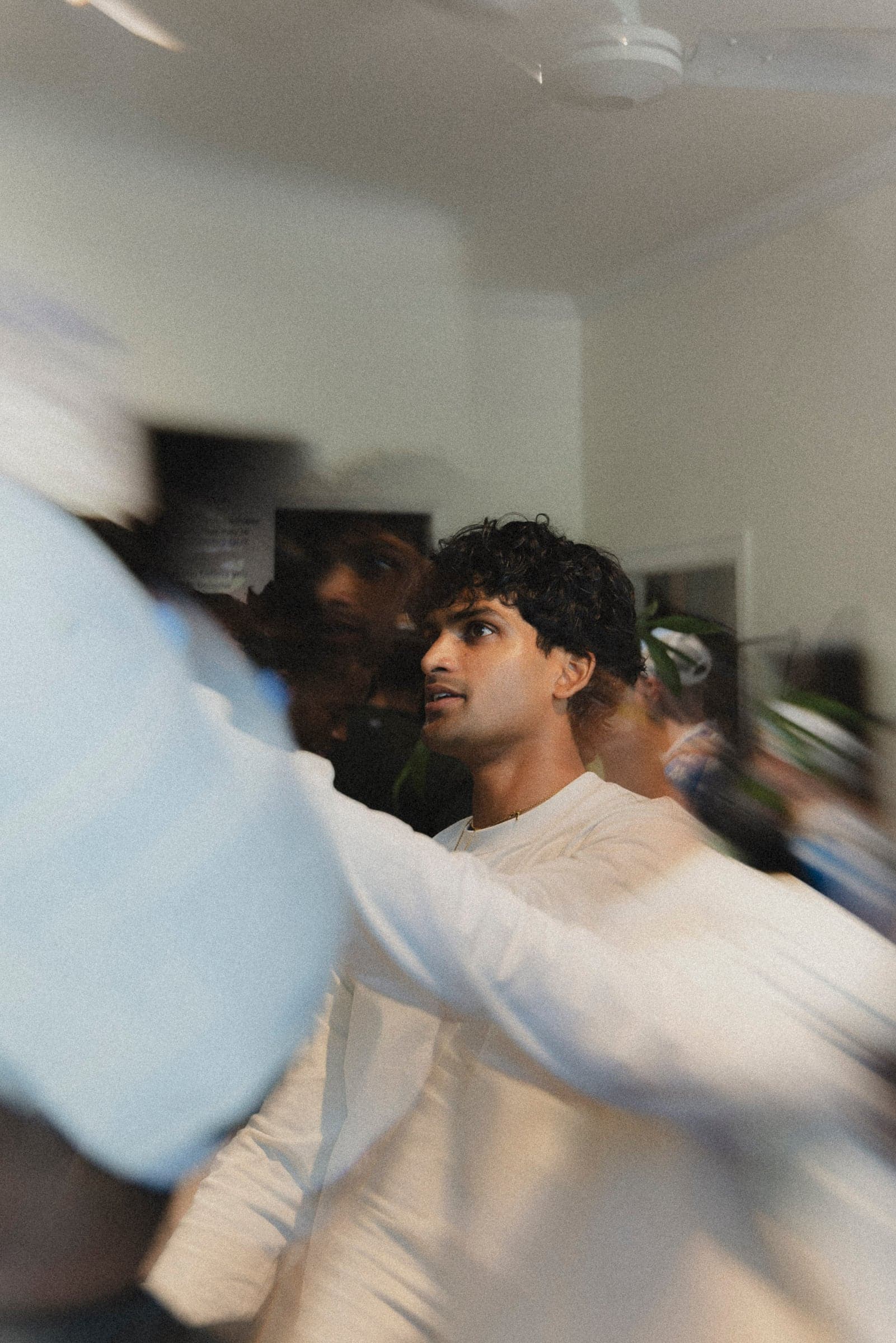 Theshantha inside the INNTW pop-up, crowd moving past in a blur